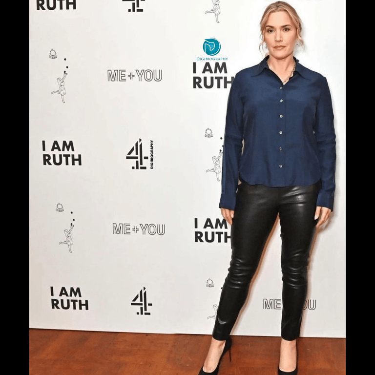 Kate Winslet wearing a blue shirt and black pent while attending a faction