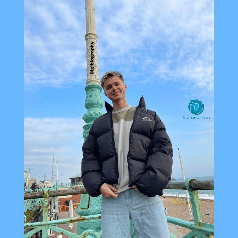 HRVY wearing a blue jacket standing on top of the building