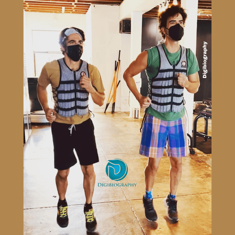 Hamish Linklater doing exercise with a friend and both are wearing a mask