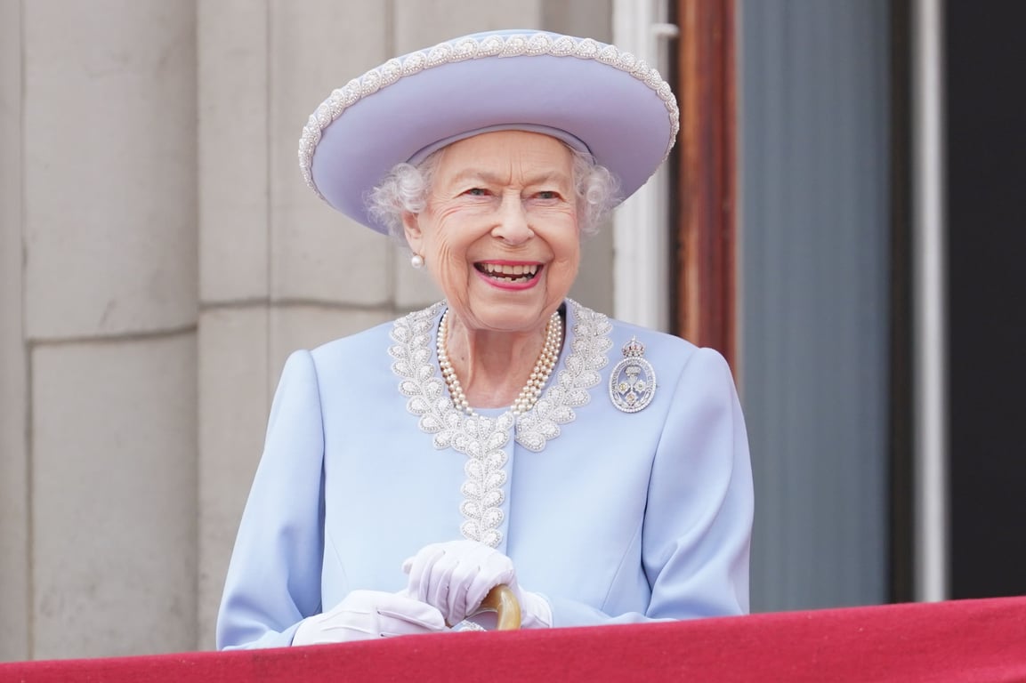 Queen Elizabeth II gives a smile to people from the terrace 