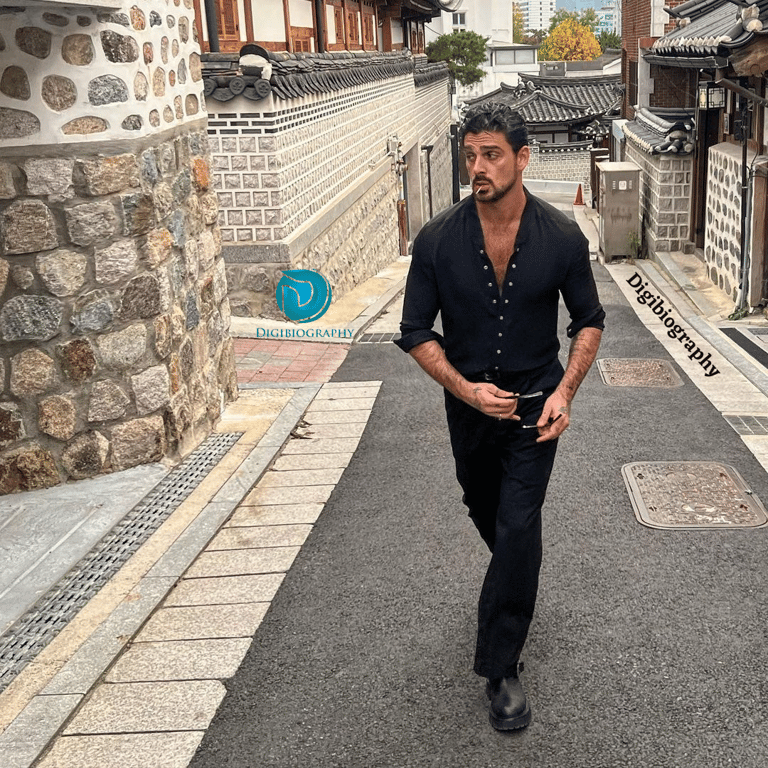 Michele Morrone walking on the road, wearing black clothes