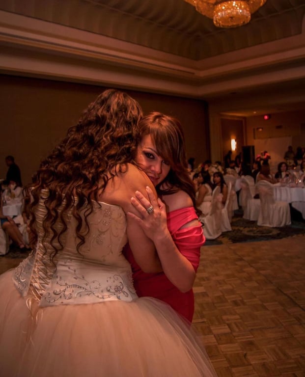 Jenni Rivera huge a friend in a red dress