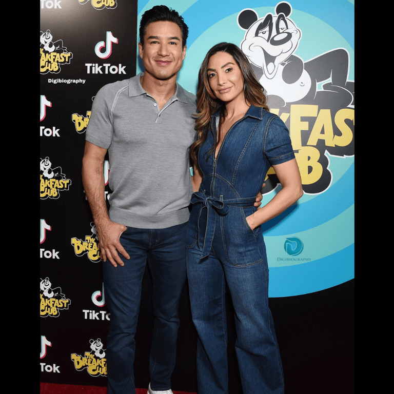 Mario Lopez wearing a gray t-shirt and stand with her wife Laine Mazza