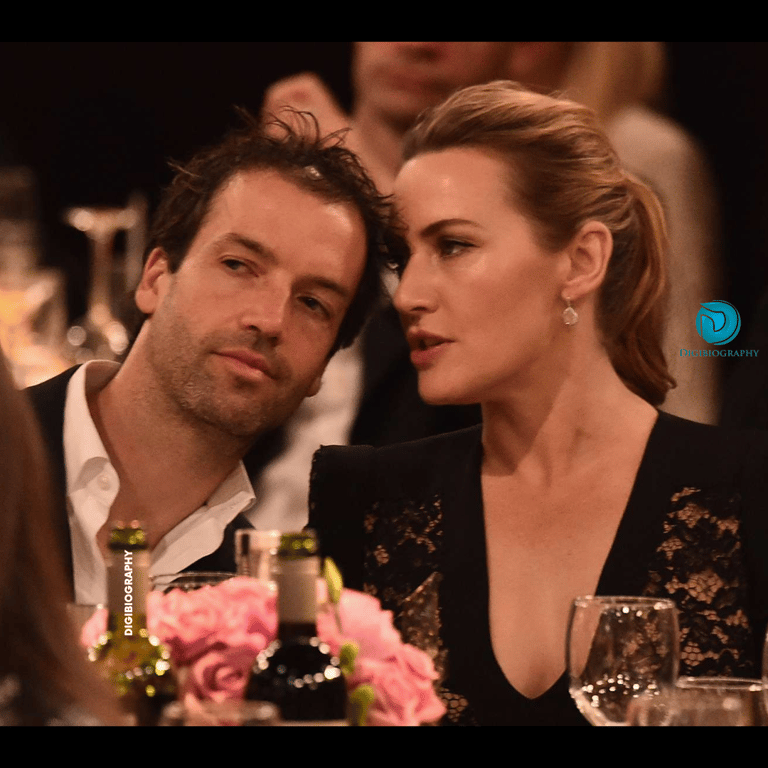 Kate Winslet sitting with her husband and saying something