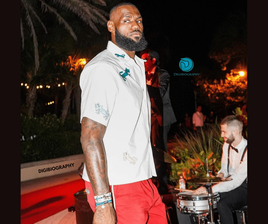 Lebron James wearing a white t-shirt and red half pent while gives a look