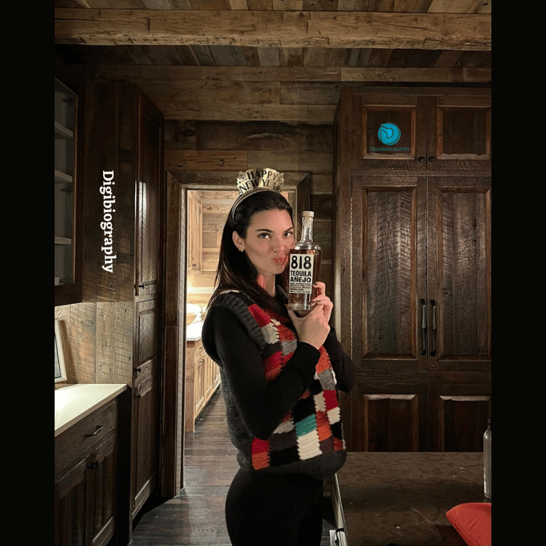 Kendall Jenner having a photo with a bottle in the old house while wearing a sweater