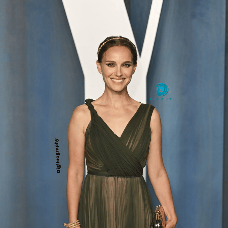 Natalie Portman gives a smile and wears a green dress