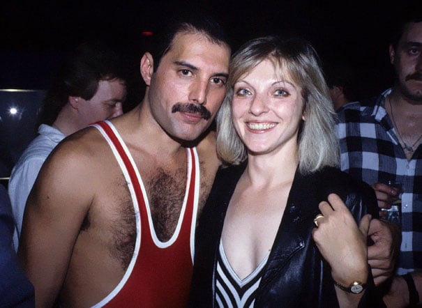 Mary Austin and Freddie Mercury picture while they stand in front of the media