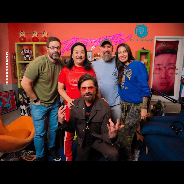 Bobby Lee standing with her co-actor while wearing a red t-shirt