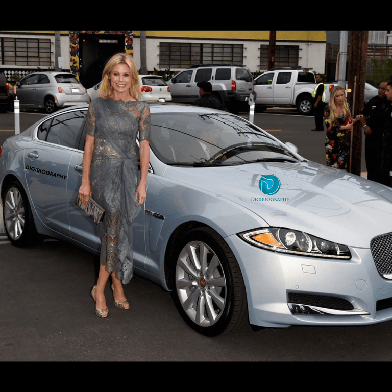 Julie Bowen stands with her new car 