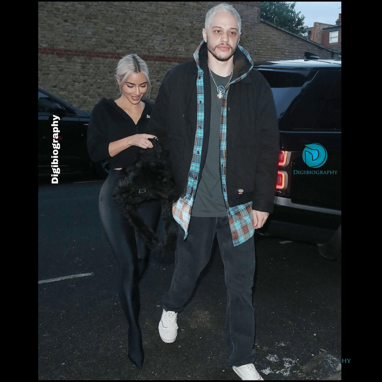 Pete Davidson wearing a jacket and walking with the girlfriend
