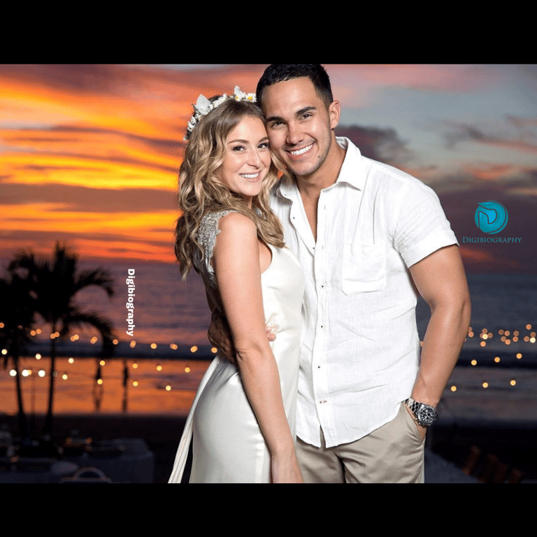 Carlos PenaVega and Alexa Vega huge each other while at sunset time and both are in white dress