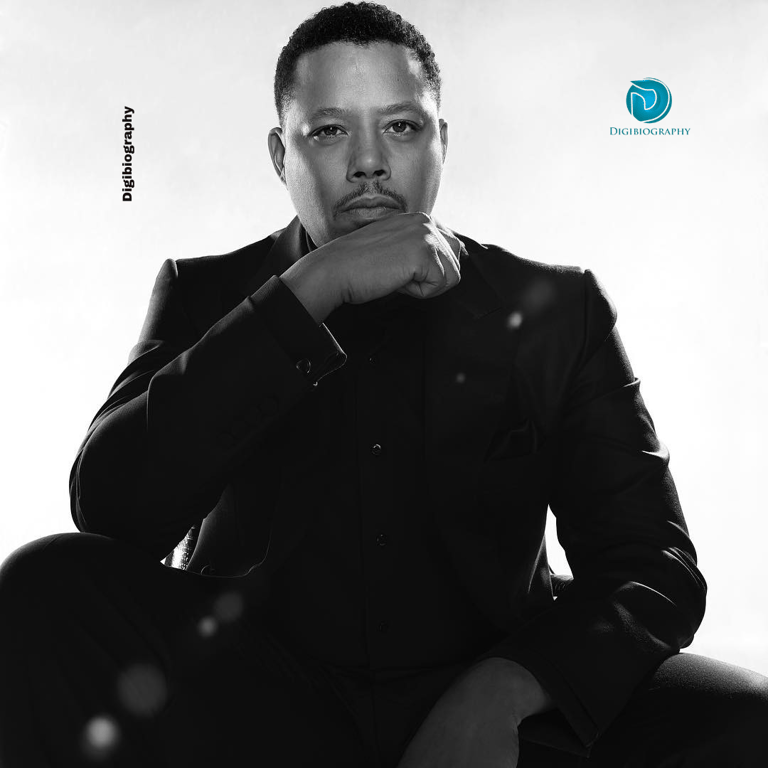 Terrence Howard wears a black suit and had a dark photo with the white background