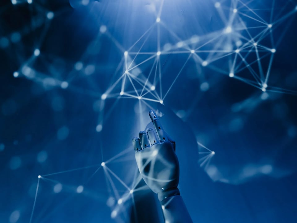 Robot hand pointing to network type nodes and connections