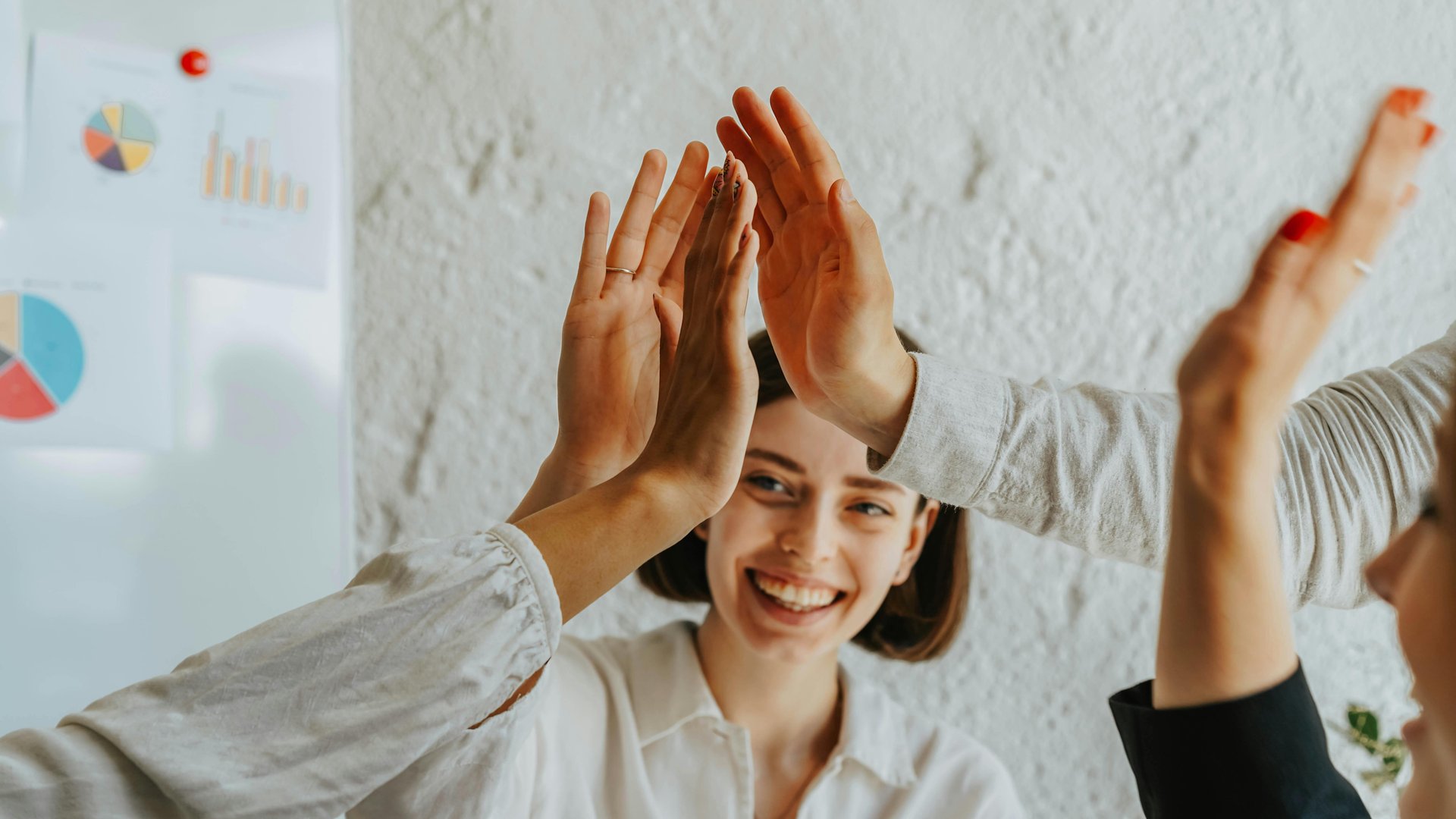 People highfiving in the office