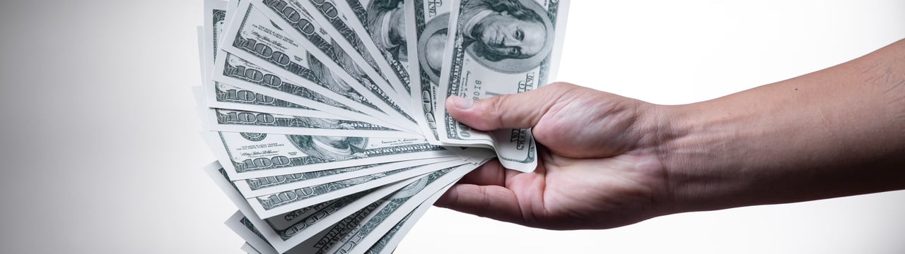 Person holding money fanned out in there hand