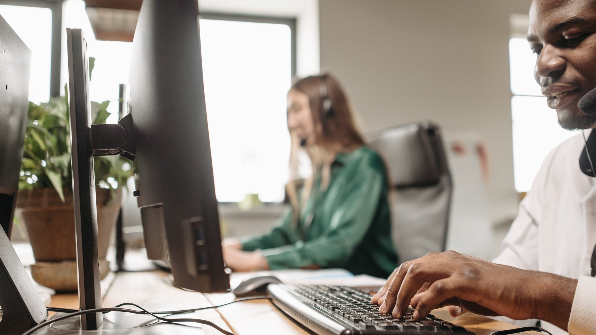 Two people in the office working on computers