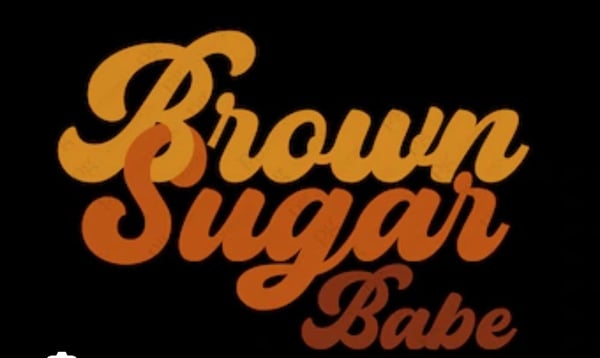 Stylized text graphic reading 'Brown Sugar Babe' in orange and yellow lettering on a black background.