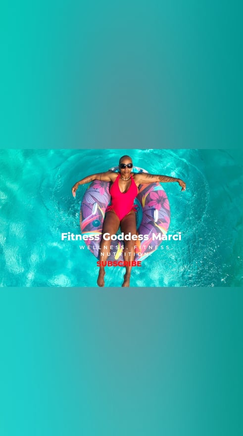 A woman relaxing in a pink swimsuit on a purple float in a turquoise pool, smiling confidently with sunglasses on.