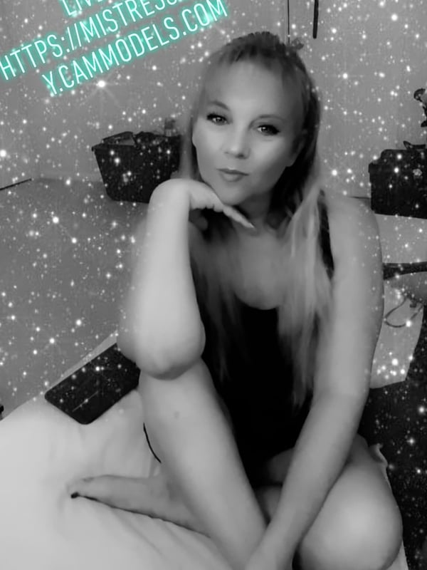 A woman with blonde hair posing confidently on furniture with sparkling effects and promotional text overlays.
