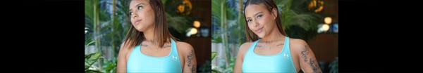 Young woman with wavy brown hair wearing a turquoise sports bra, posing confidently indoors with tropical plants in the background.