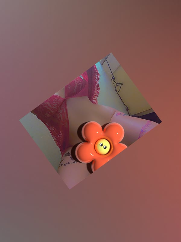 Artistic image featuring a vibrant orange flower and pink elements on a warm gradient background.