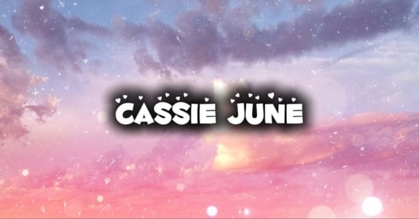 Aesthetic graphic with the text 'CASSIE JUNE' overlaid on a vibrant purple and pink sunset sky with sparkling effects.