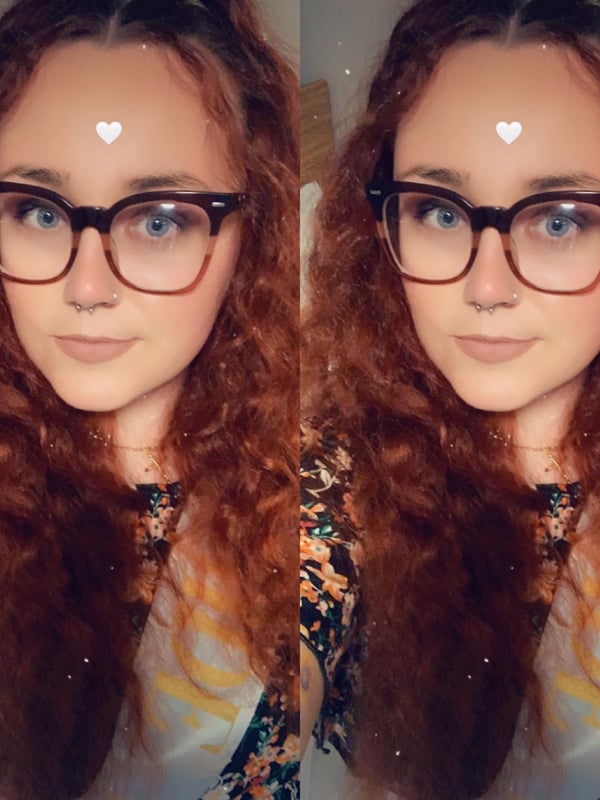 Young woman with long red curly hair, wearing glasses and a floral top, posing with heart emojis on her forehead in a split image.