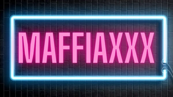 Neon pink sign with 'MAFFIAXXXXX' text glowing against a dark background.