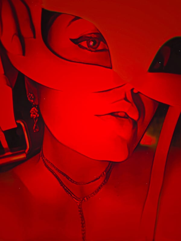 Close-up portrait of a woman wearing a red mask and jewelry, with dramatic red lighting highlighting her face.