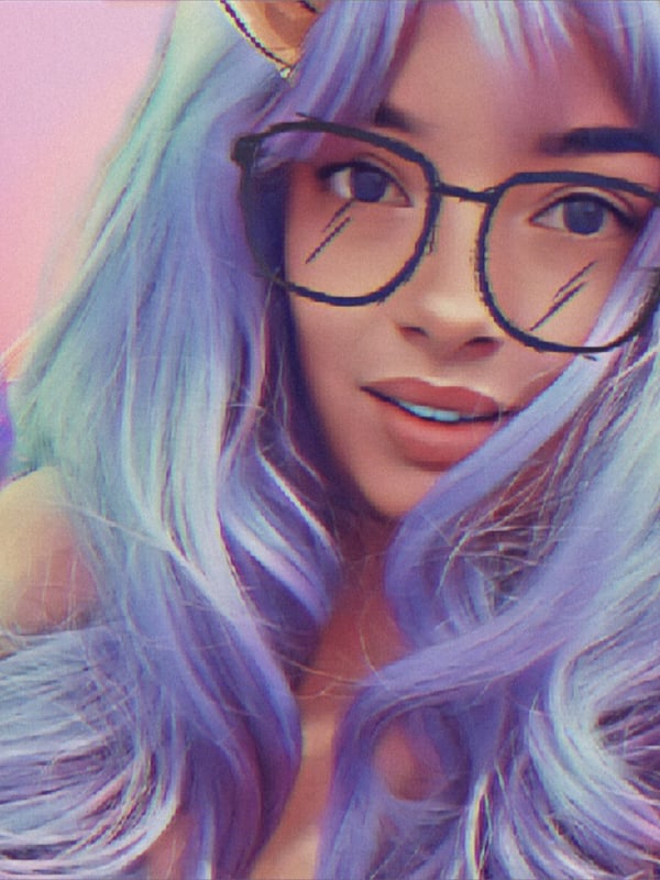 A woman with long light blue hair, black glasses, and playful ear accessories posing with a subtle smile against a pink background with floral elements.