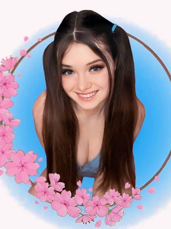 Smiling young woman with dark hair in blue pigtail ribbons, framed in a blue circle with pink cherry blossoms.