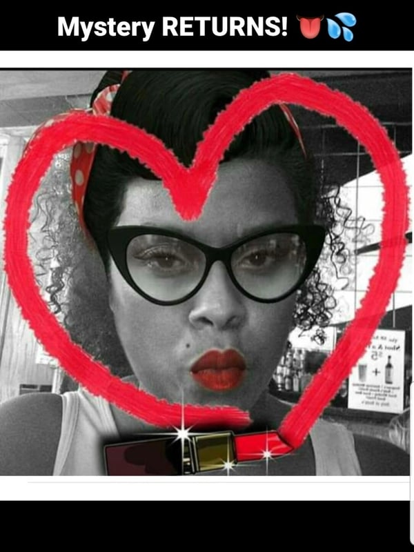 Close-up portrait of a woman with dark hair in a retro headscarf and bold red lips, framed by a large red hand-drawn heart, with 'Mystery RETURNS' text overlay.