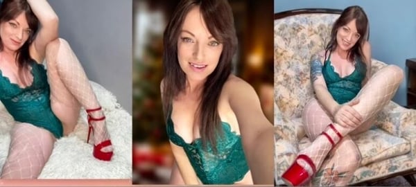 A woman posing in green lace lingerie and fishnet stockings on a white fluffy surface and a floral armchair.