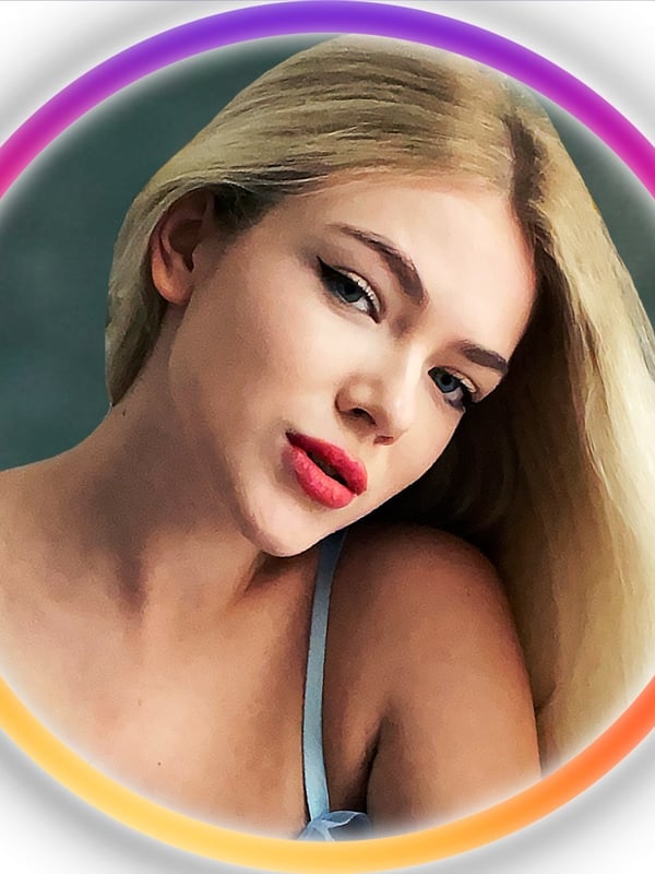 Close-up portrait of a young woman with long blonde hair, subtle makeup, and a confident expression, framed in a colorful glowing circle.