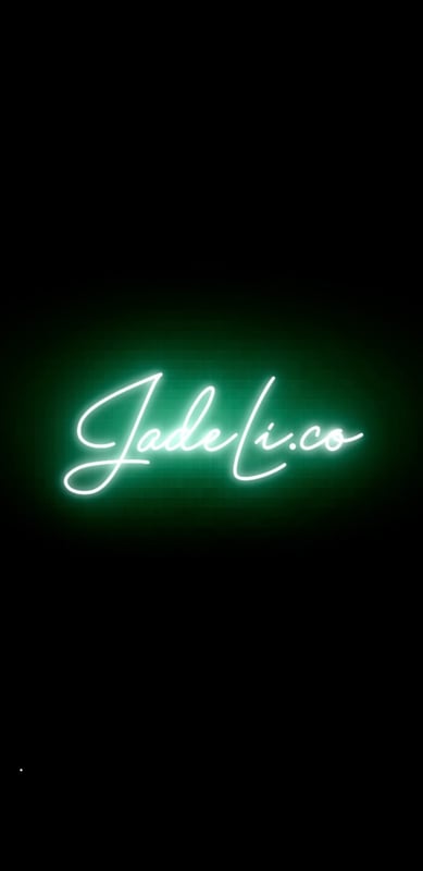 Neon green glowing sign displaying the name 'Jade Li' against a dark background.