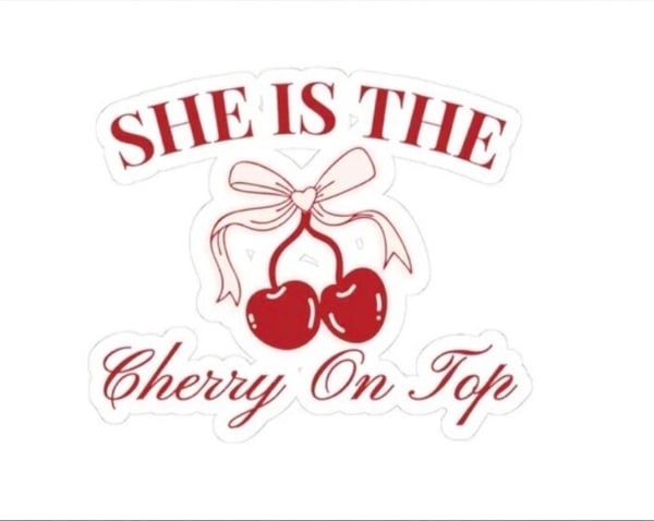 Graphic design featuring red cherries with ribbons and the text 'She is the Cherry on Top' in elegant lettering.