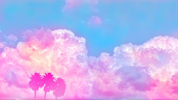 A vibrant pink and blue sky with fluffy clouds and silhouetted palm trees.