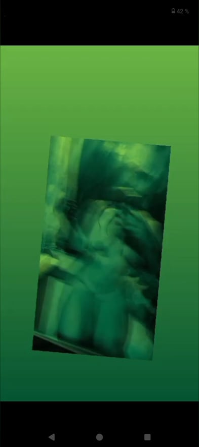 A person posing in a green-tinted artistic image with a blurred, dynamic effect.