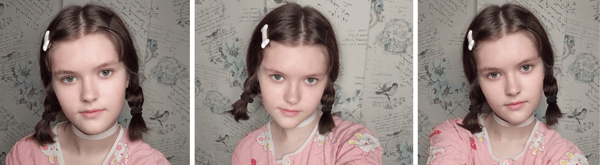 A young woman with brown hair in pigtails wearing a pink top, posing in front of a patterned background.