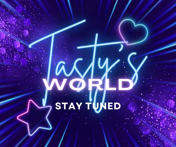 Vibrant neon sign featuring 'Tasty's World' in glowing purple and pink letters with stars, hearts, and 'Stay Tuned' text against a sparkling purple background.