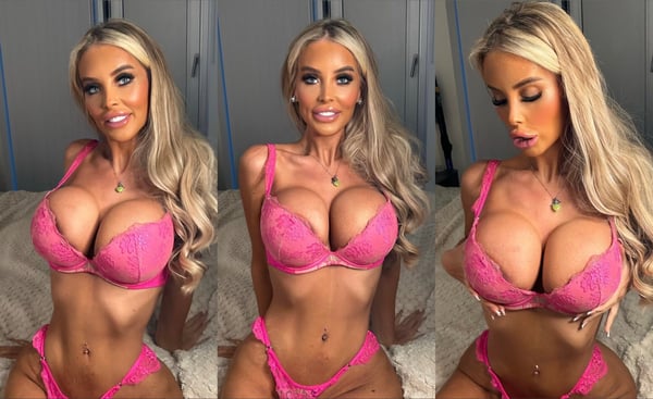A person with long blonde hair posing confidently in bright pink lingerie against a bedroom backdrop.