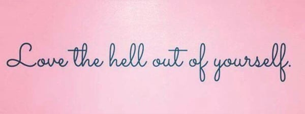 Pink background with elegant scripted text reading 'Love the hell out of yourself.'
