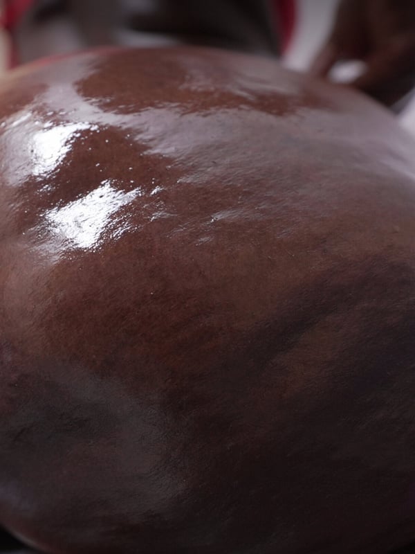 Close-up of a large, rounded, shiny backside in a red garment.