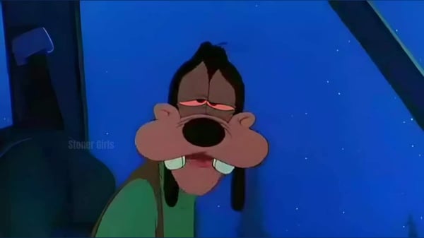 Cartoon character Goofy with a tired expression, wearing green clothing against a blue background.