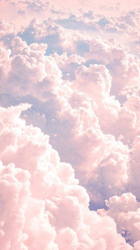 A dreamy landscape of soft pink and blue clouds filling the sky.