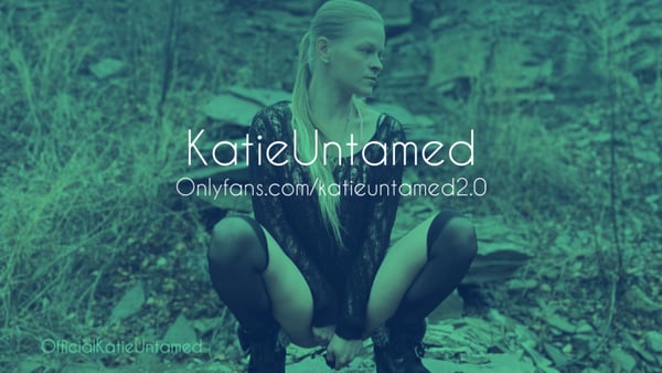 Woman with blonde ponytail squatting in a forest setting, wearing dark stockings and top, with green overlay and text overlay.