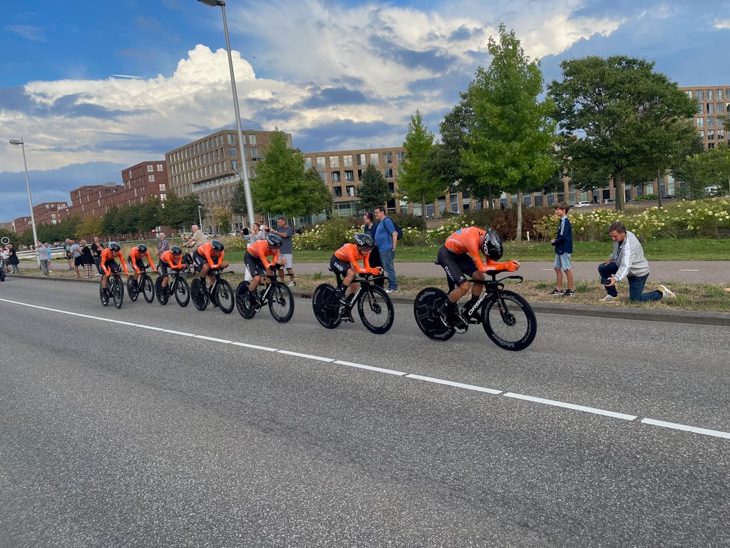 Team in Orange Jerseys Competing in Time Trial