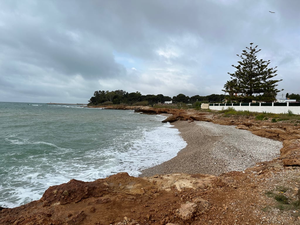 Rocky Coastline Under Cloudy Sky