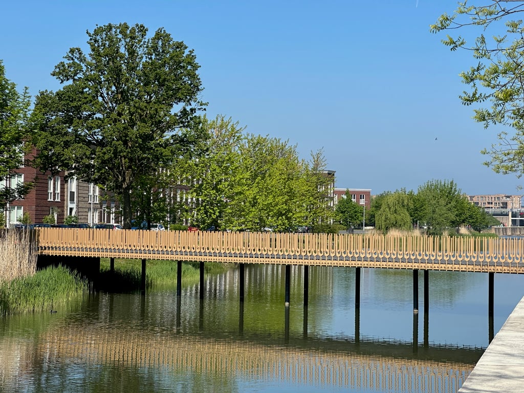 Modern Wooden Bridge Over a City Canal